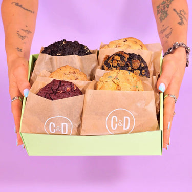 6 x New York Cookies, The Thank You Box by Crumbs & Doilies held in hands with six assorted cookies inside.